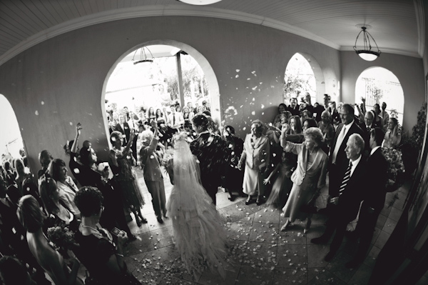 wide angle perspective of couple exiting ceremony - wedding photo by Australia based wedding photographer Natasha Du Preez